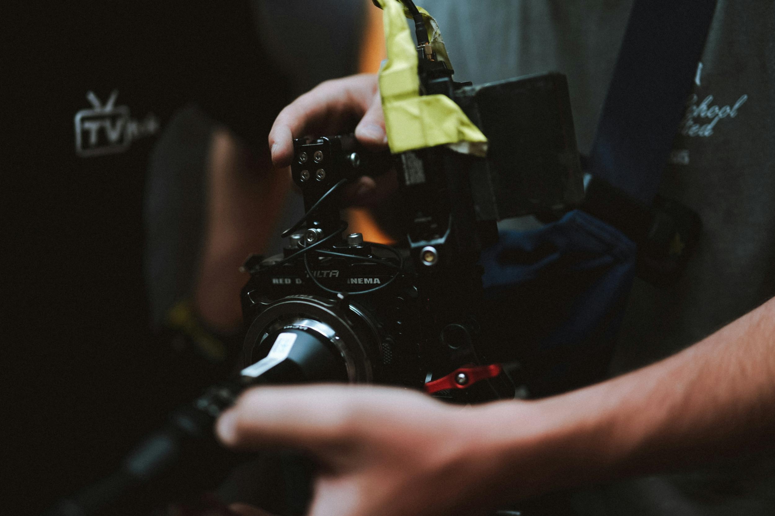 close up of a cameraman holding a camera