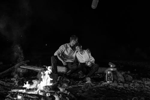 Father and Son Sitting by the Campfire 