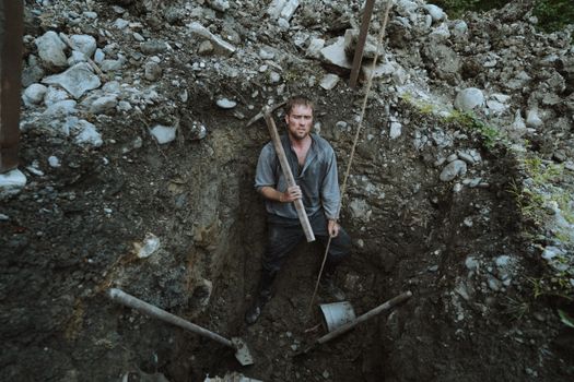 Man with Pickax in Hole