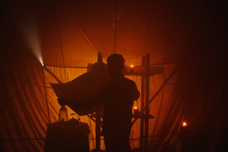 Man With Lantern And Plan In Darkness