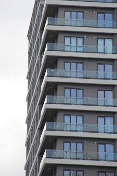 Contemporary architecture featuring stacked glass balconies on a high-rise building facade.