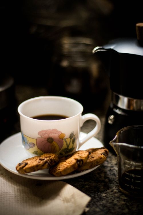 Free Warm coffee served with chocolate chip cookies for a cozy break. Stock Photo