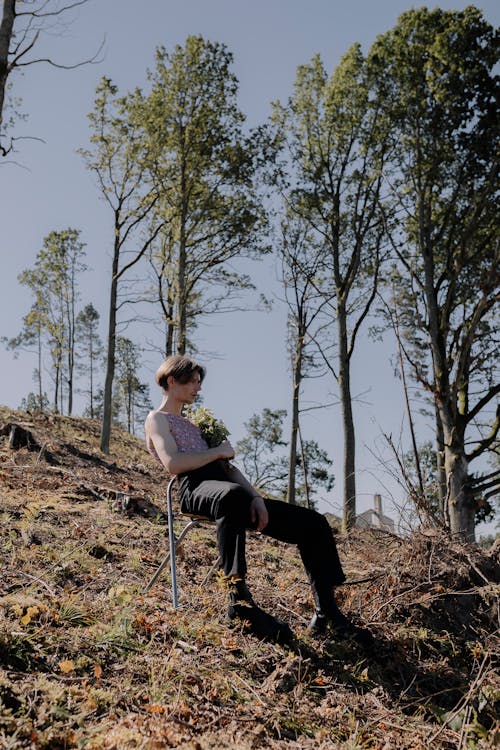 Man Sitting on a Chair in the Forest 