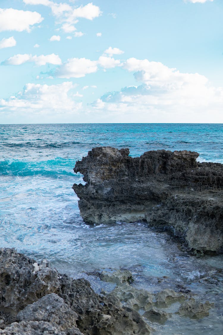 Photo Of Rock Formation On Sea During Daytime