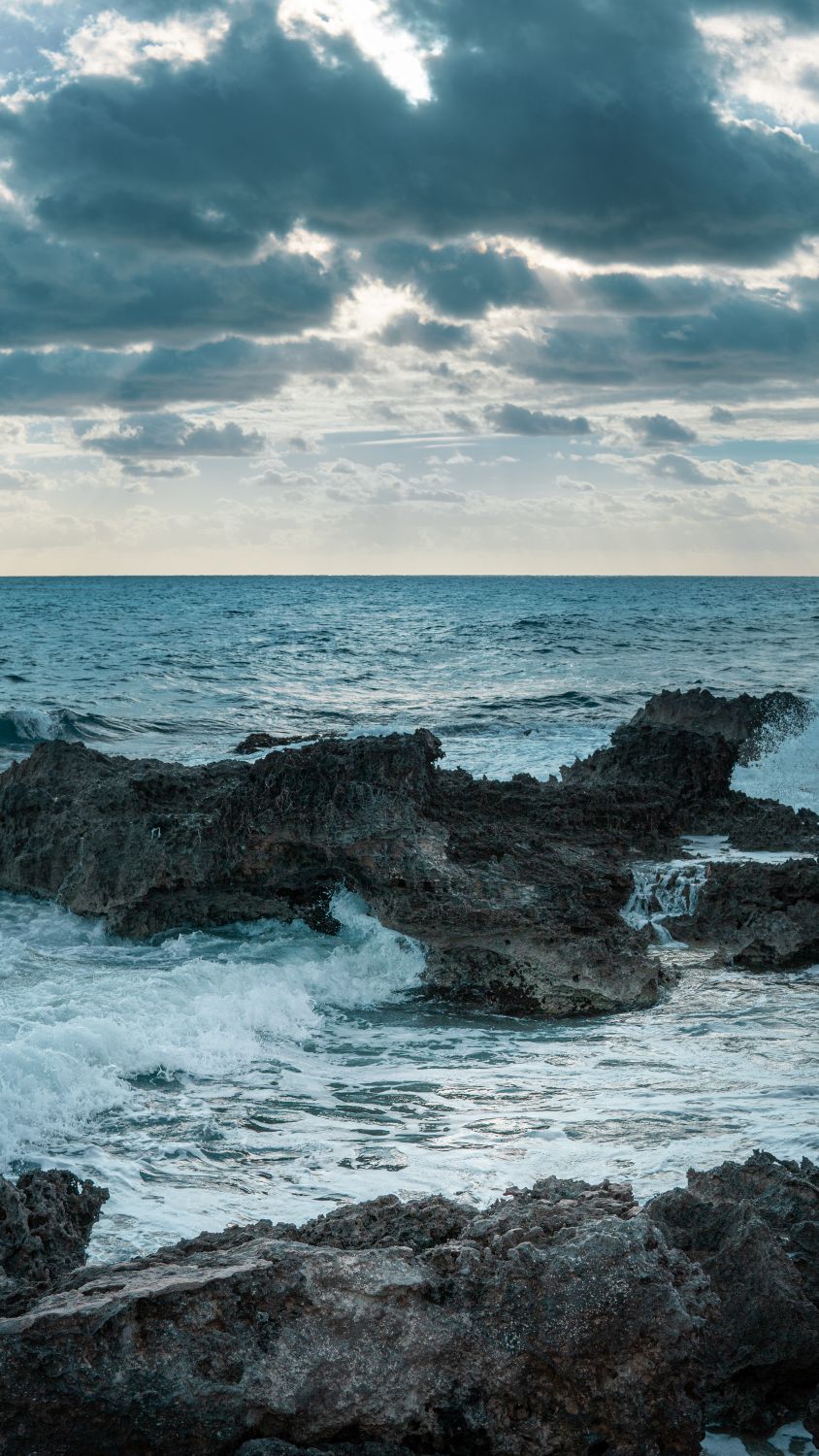 Rocks on the Ocean under the Cloudy Sky · Free Stock Photo