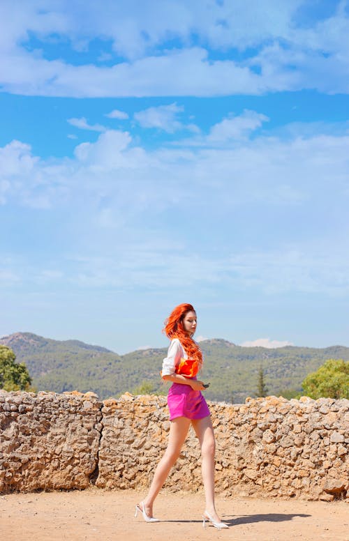 Free Woman in White Shirt and Pink Shorts Walking Stock Photo