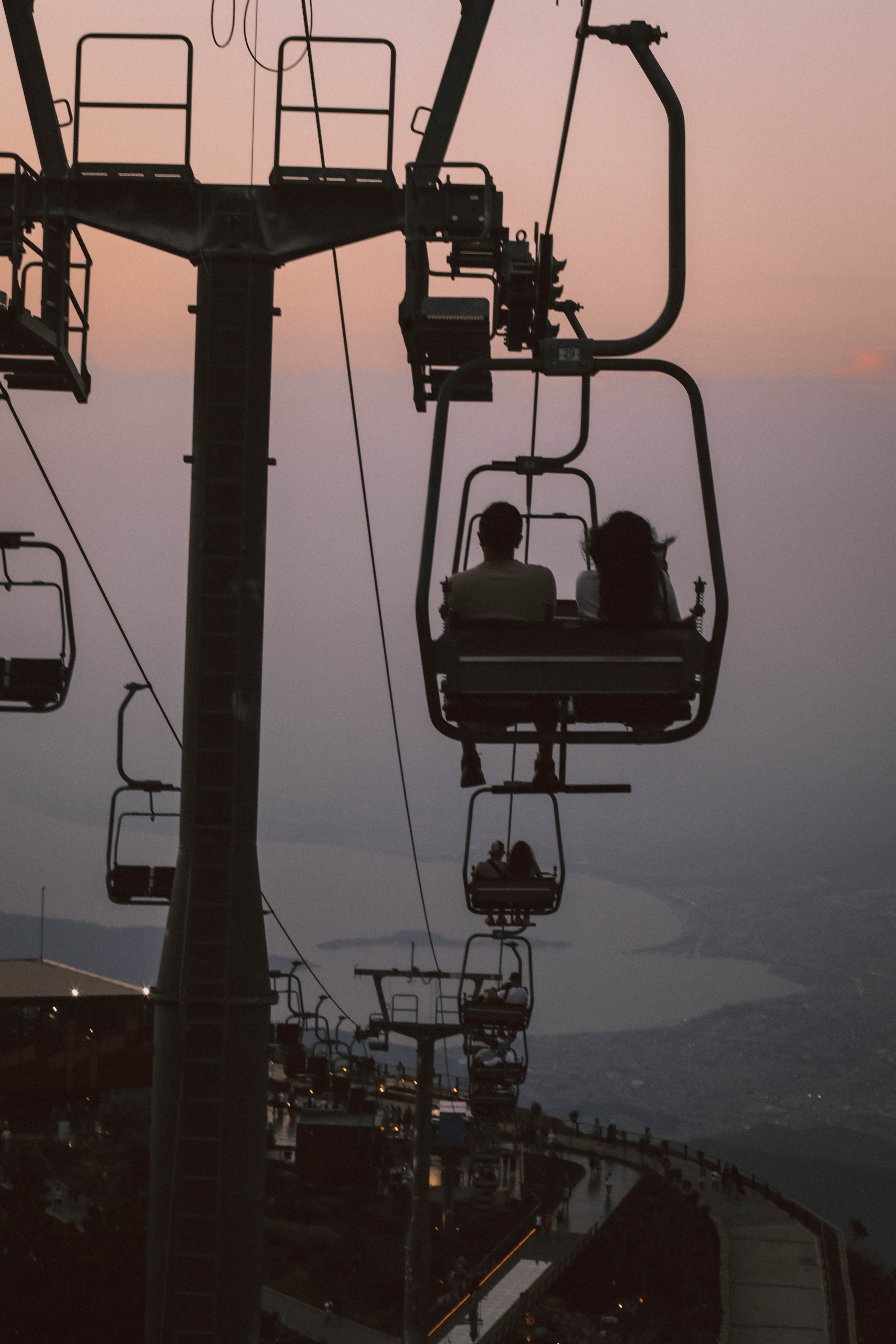 Experience a serene chairlift ride overlooking Fethiye Bay at sunset, capturing leisure and travel vibes.