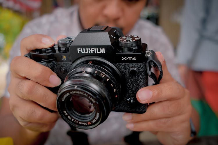 Man Holding FujiFilm Camera