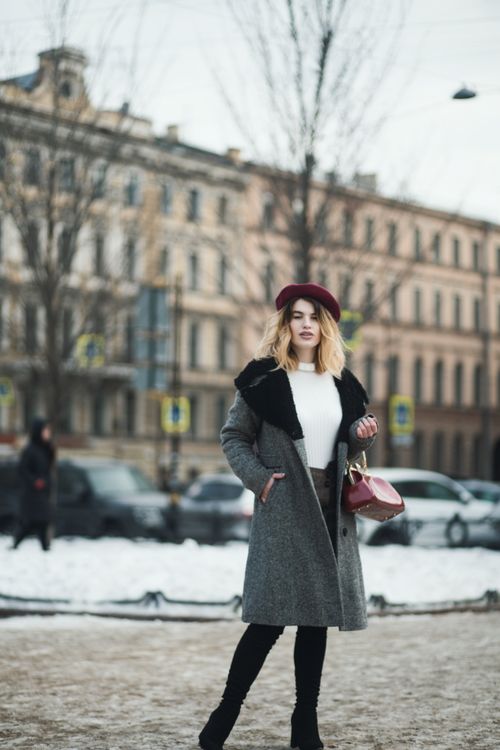 Free Fashionable woman in grey coat poses outdoors in winter cityscape, showcasing urban style. Stock Photo