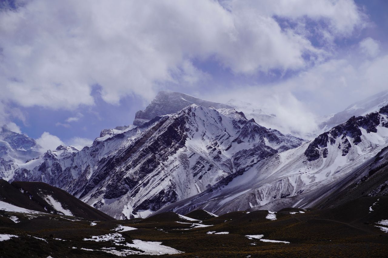 experience the majestic snow covered andes mountains under a cloudy sk