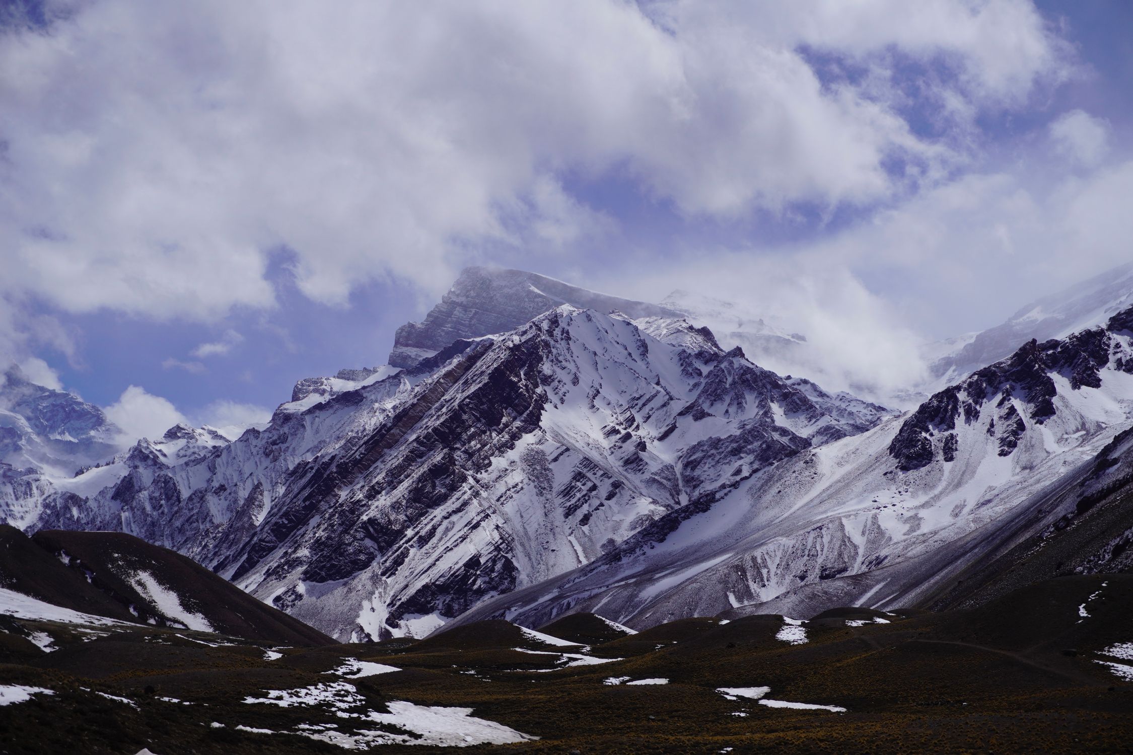 Snow Covered Mountain Under Cloudy Sky · Free Stock Photo