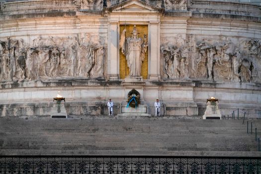 The grand facade of the Vittoriano Monument in Rome, featuring guards and sculptures.