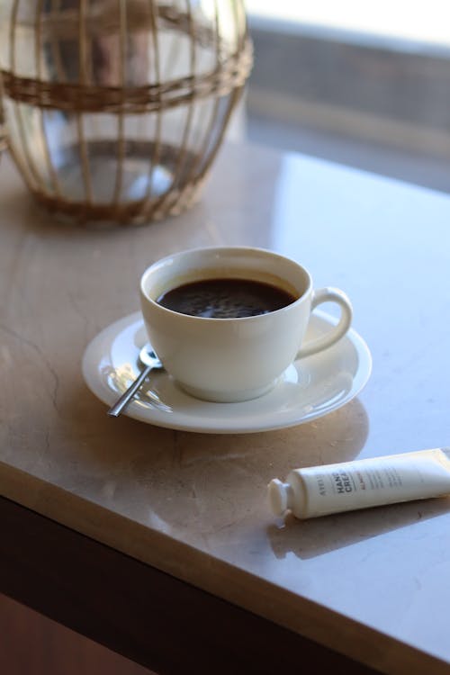 A Cup of Coffee on a Saucer with Teaspoon