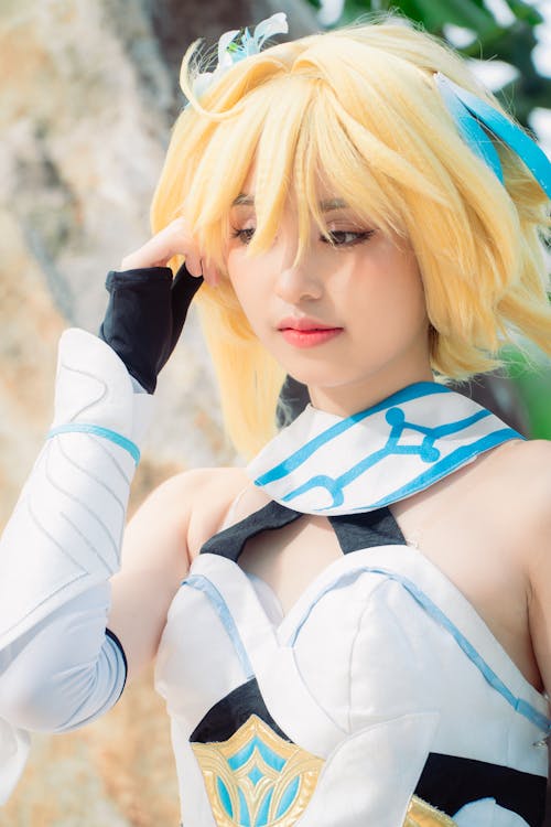 A Woman Cosplaying Lumine from Genshin Impact