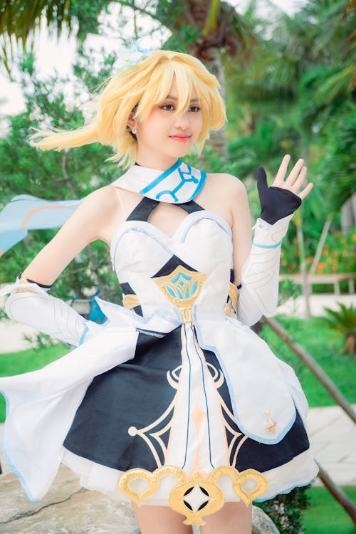 A Woman Cosplaying Lumine from Genshin Impact