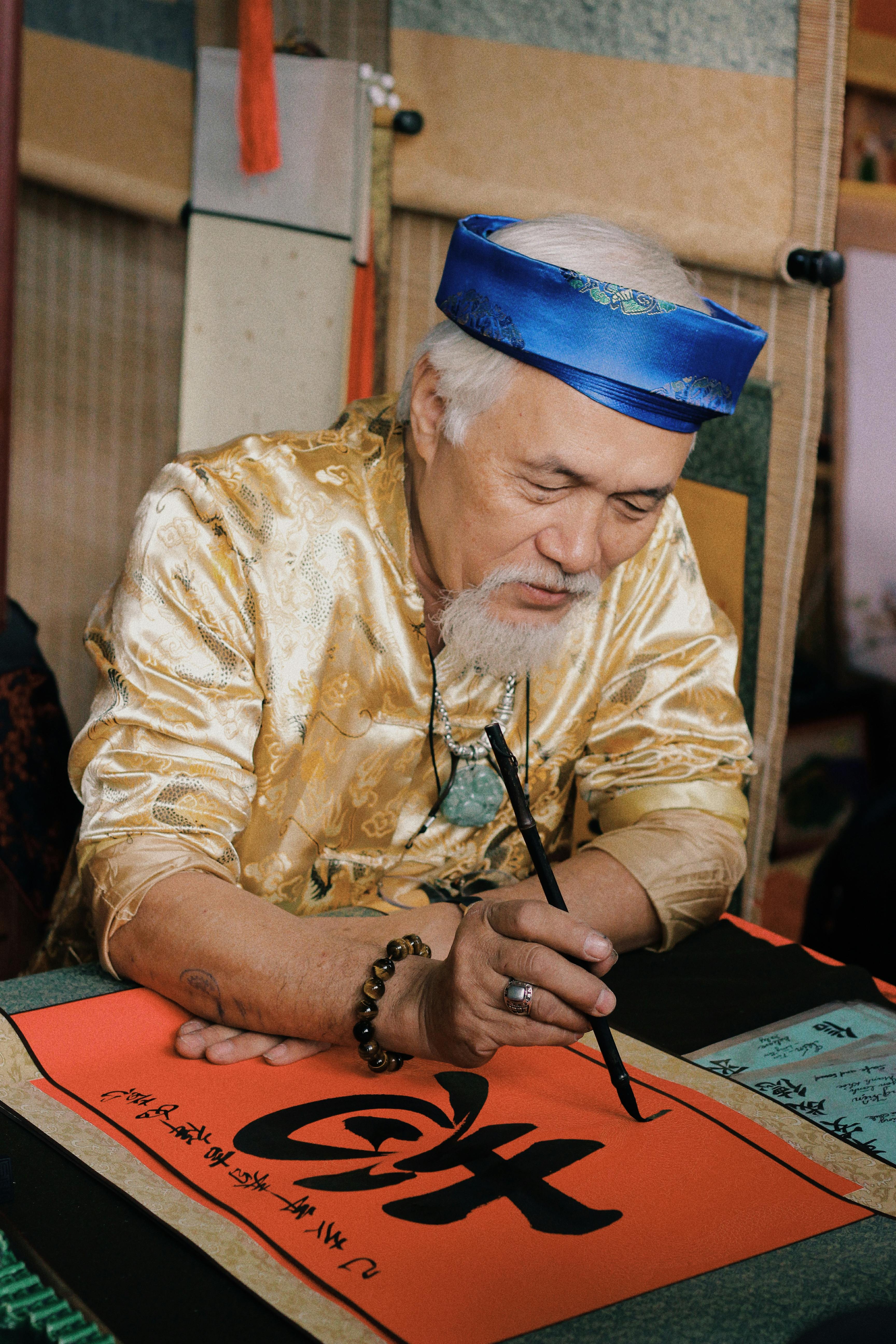 Elderly man engaged in traditional calligraphy art in Hà Nội, Vietnam.