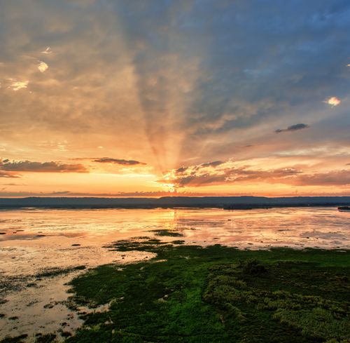Free A breathtaking sunset over wetlands in Minnesota with vibrant colors and dramatic skies. Stock Photo