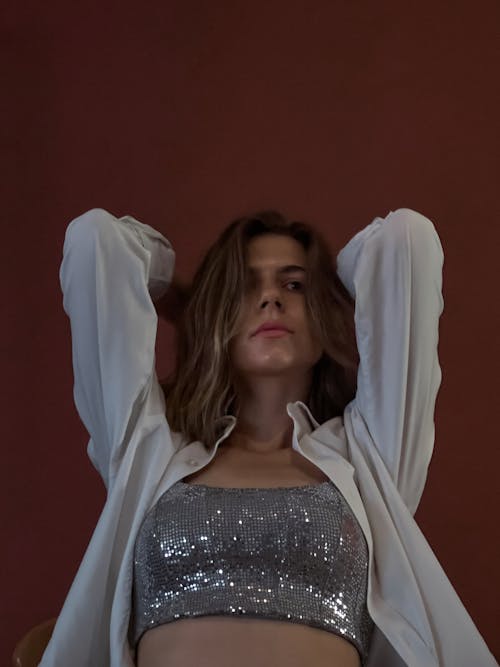 A Woman in Silver Crop Top and White Cardigan