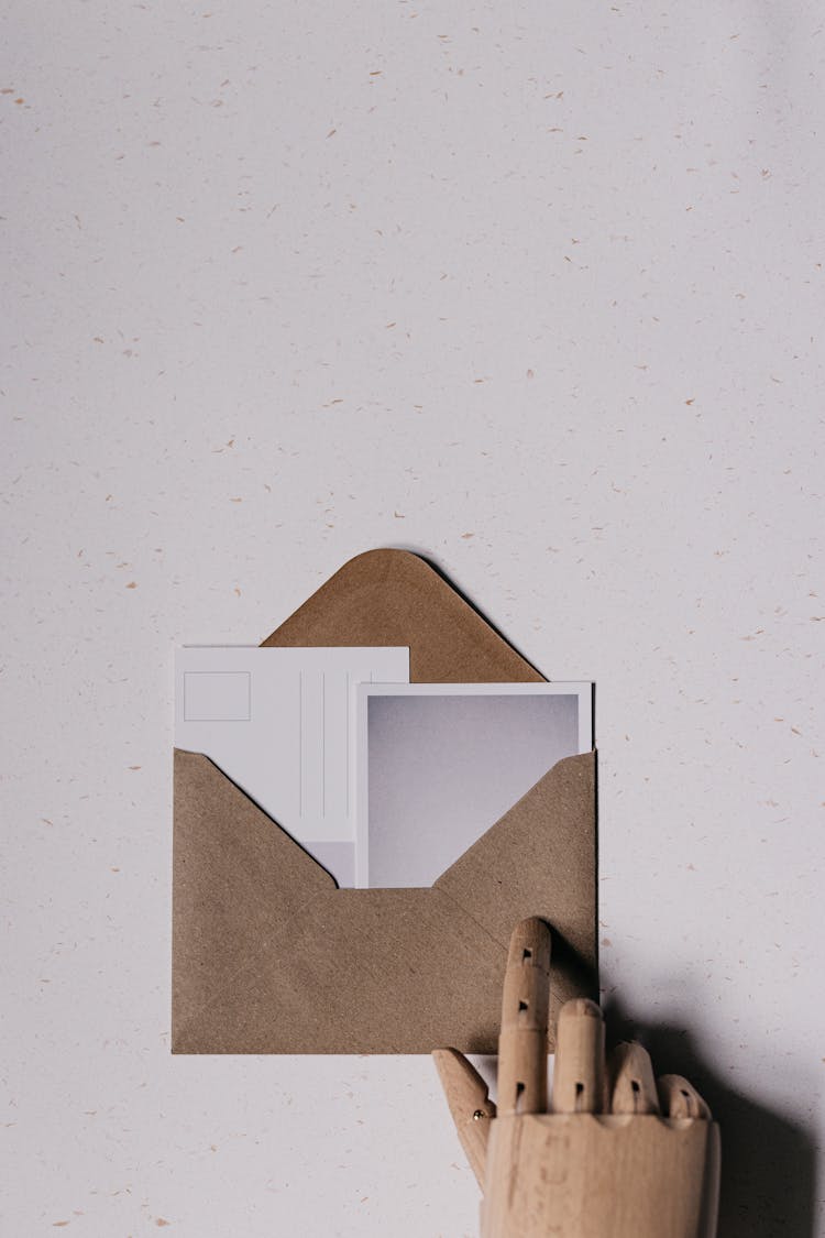 Wooden Hand Touching An Envelope 