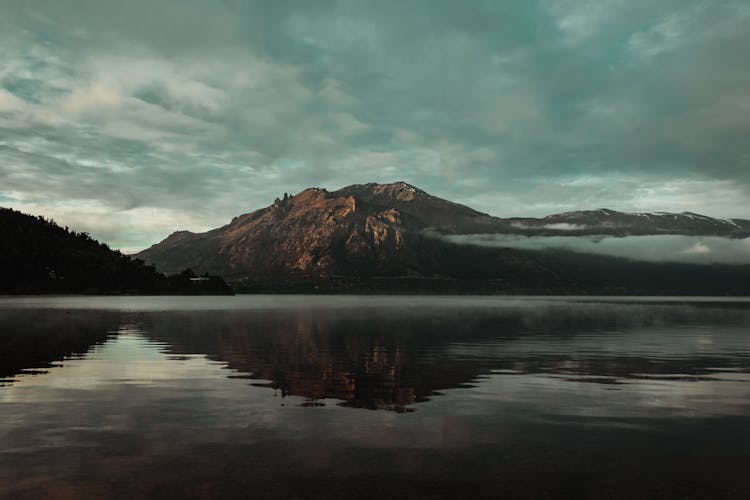 A Lake With A Mountain In The Background