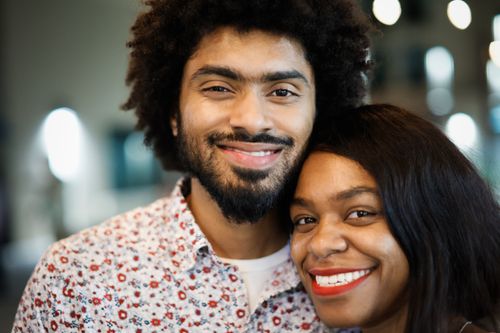 Free A joyful couple smiling together, capturing positive energy and affection. Stock Photo