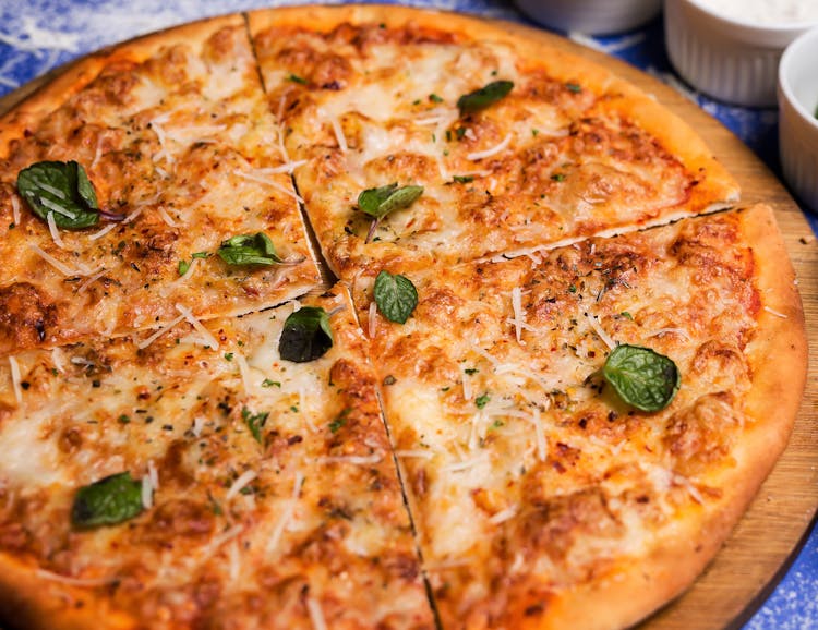 Pizza With Basil Toppings In Close-up Photography