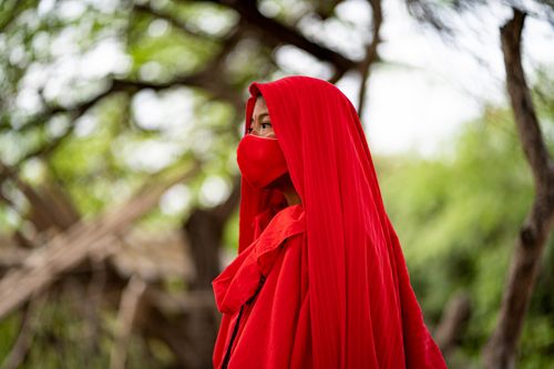 Free A person wearing traditional red clothing and mask in Guajira, Colombia. Vibrant and cultural setting. Stock Photo