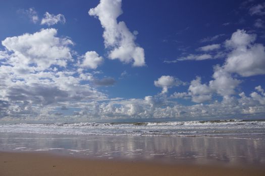 A beautiful beach scene in Oostende, Belgium, featuring clouds and a serene ocean view.