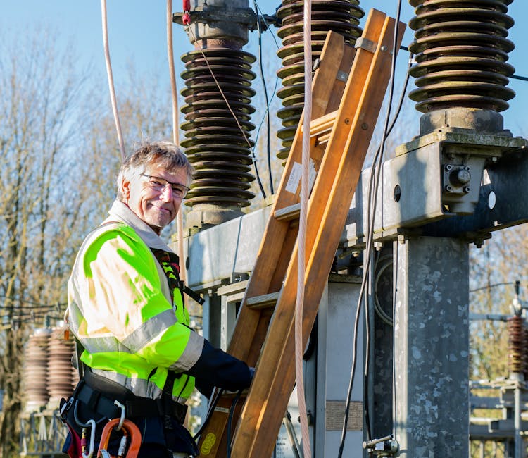 Worker At Electrical Transformer Substation