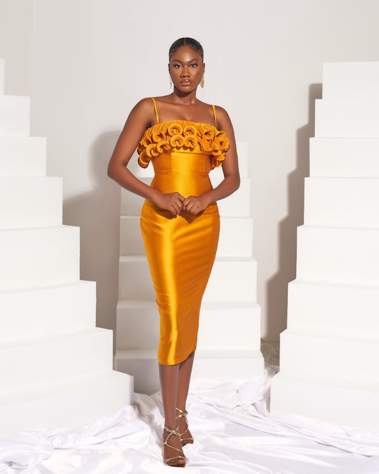 Woman Posing In A Yellow Satin Dress