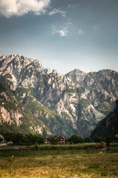 A Rocky Mountain Near the Green Grass Field