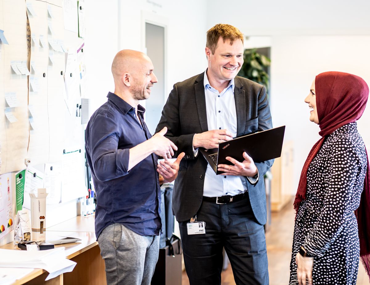 Consultants meeting clients, including a woman in a hijab