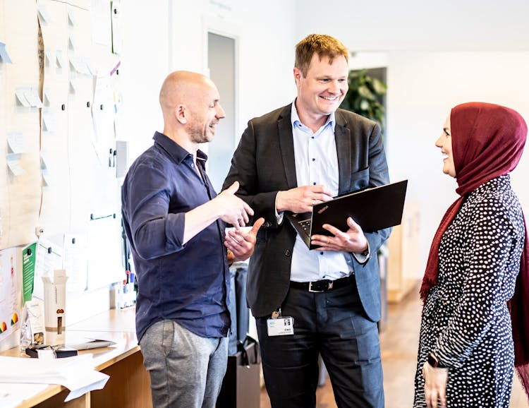 A Group Of People At Work Chatting