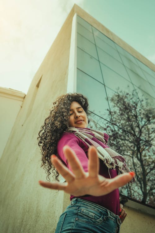 Low-Angle Shot of a Woman with Curly Hair