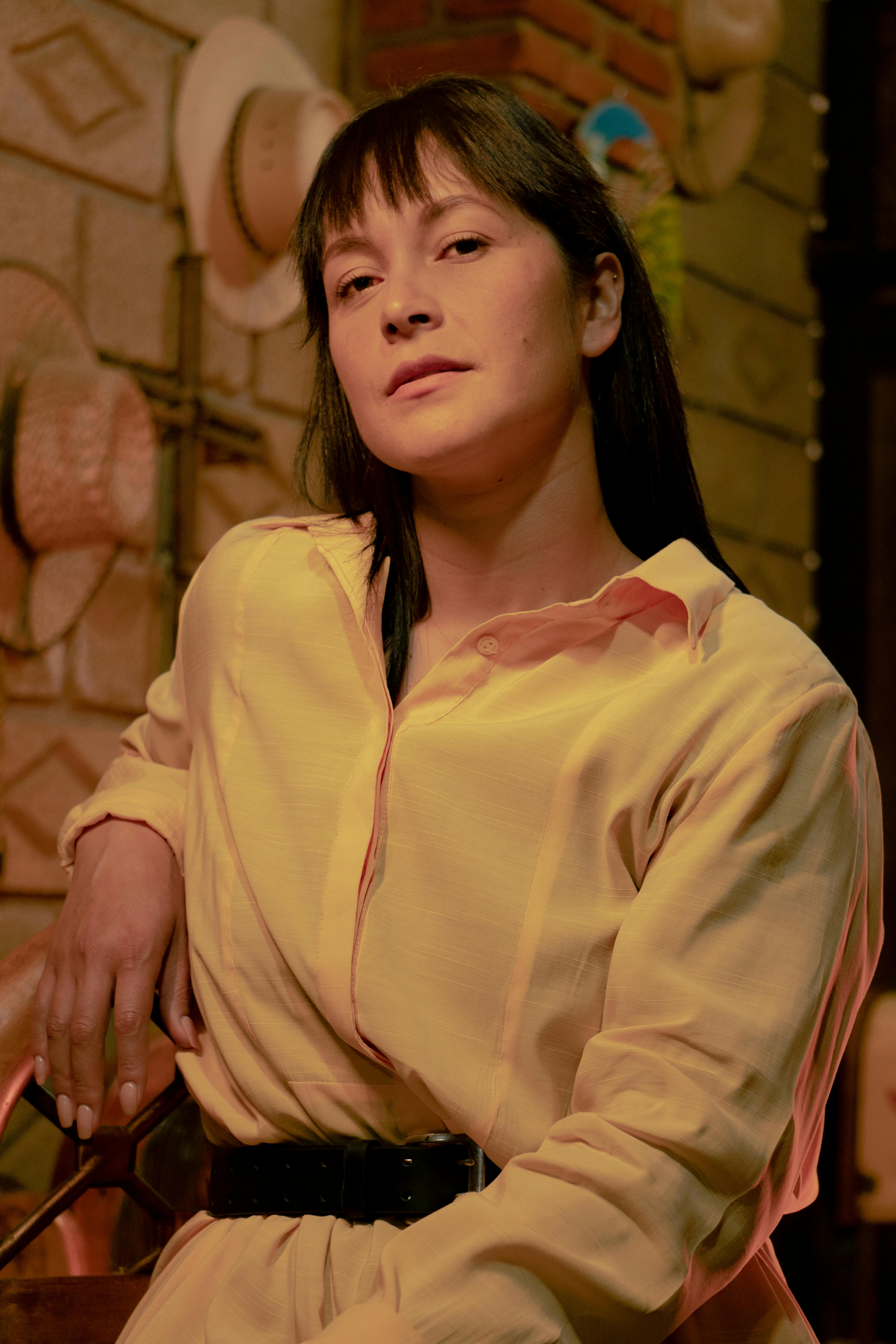 Portrait of a woman in a rustic, hat-adorned setting in Ciudad de México, CDMX, México.