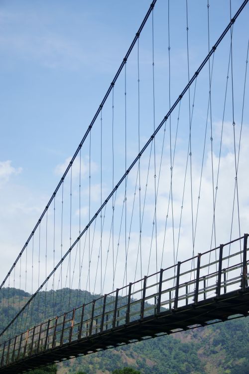 Free Low angle view of a suspension bridge in Ernakulam, India, against a clear blue sky. Stock Photo