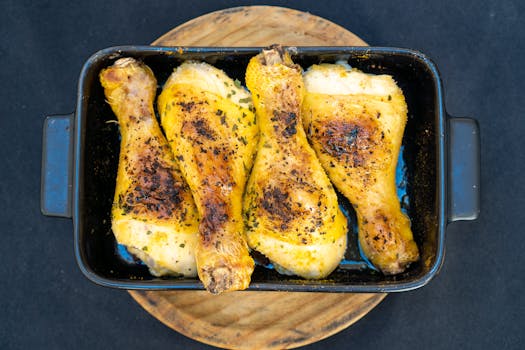 Delicious baked chicken drumsticks perfectly cooked in a pan.