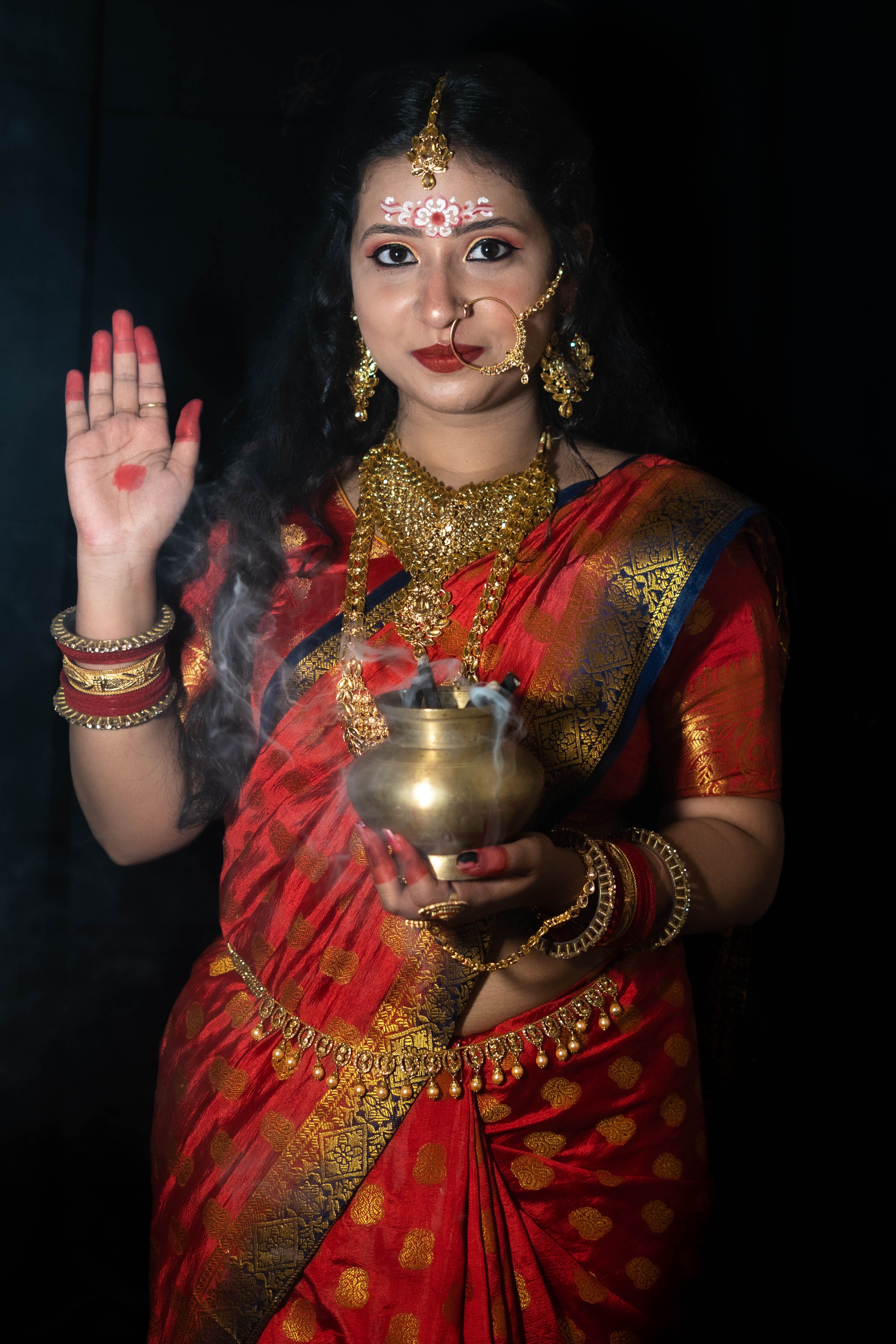 Woman in a Red Sari Wearing Traditional Jewelry · Free Stock Photo