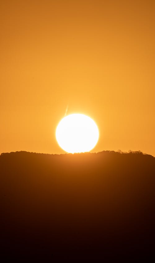 Безкоштовне стокове фото на тему «вертикальні постріл, Захід сонця, помаранчеве небо»