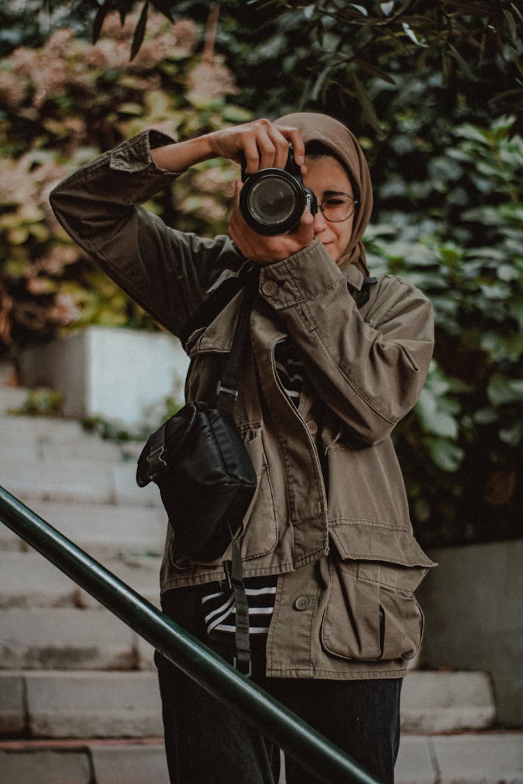 Young Woman Taking A Picture With A Camera 