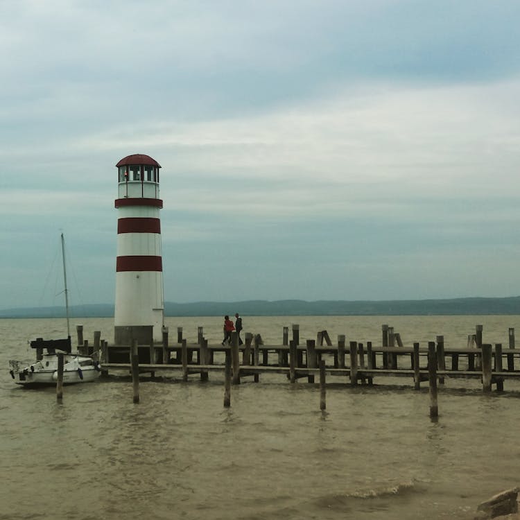 People Walking On Wooden Jetty