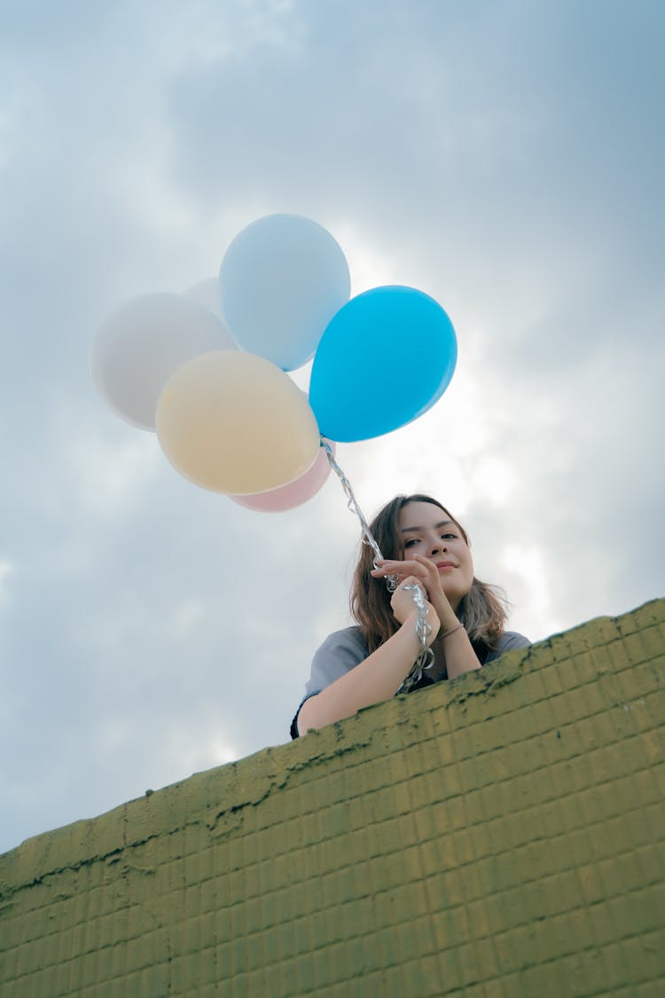 A Woman Holding Balloons