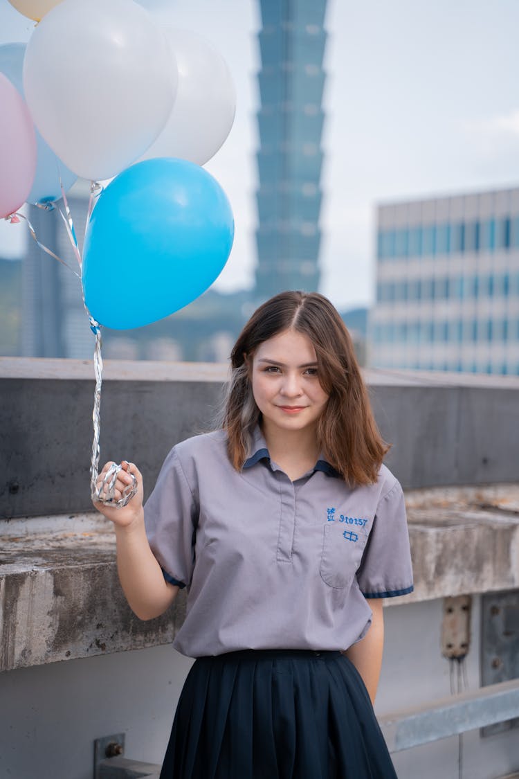 A Woman Holding Balloons