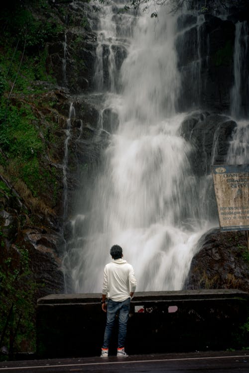 Young Indian model in front of waterfall at Idukki Kerala long exposure