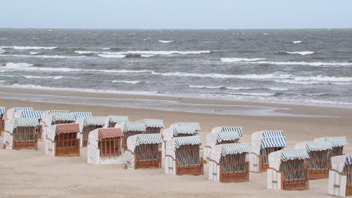 Brown Wooden Chairs on Beach