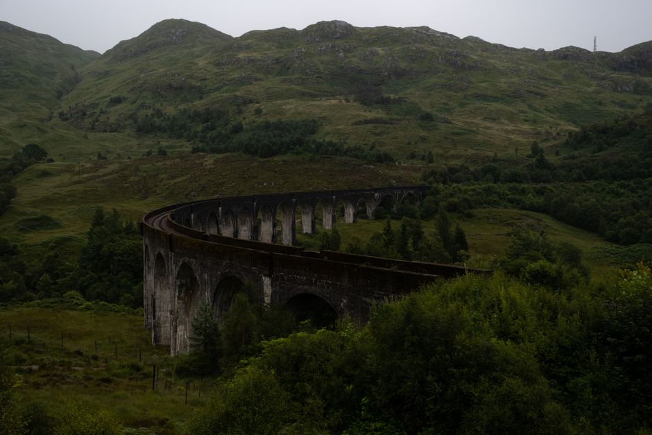 Scenic view of the historic Glenfinnan Viaduct in the lush Scottish Highlands.