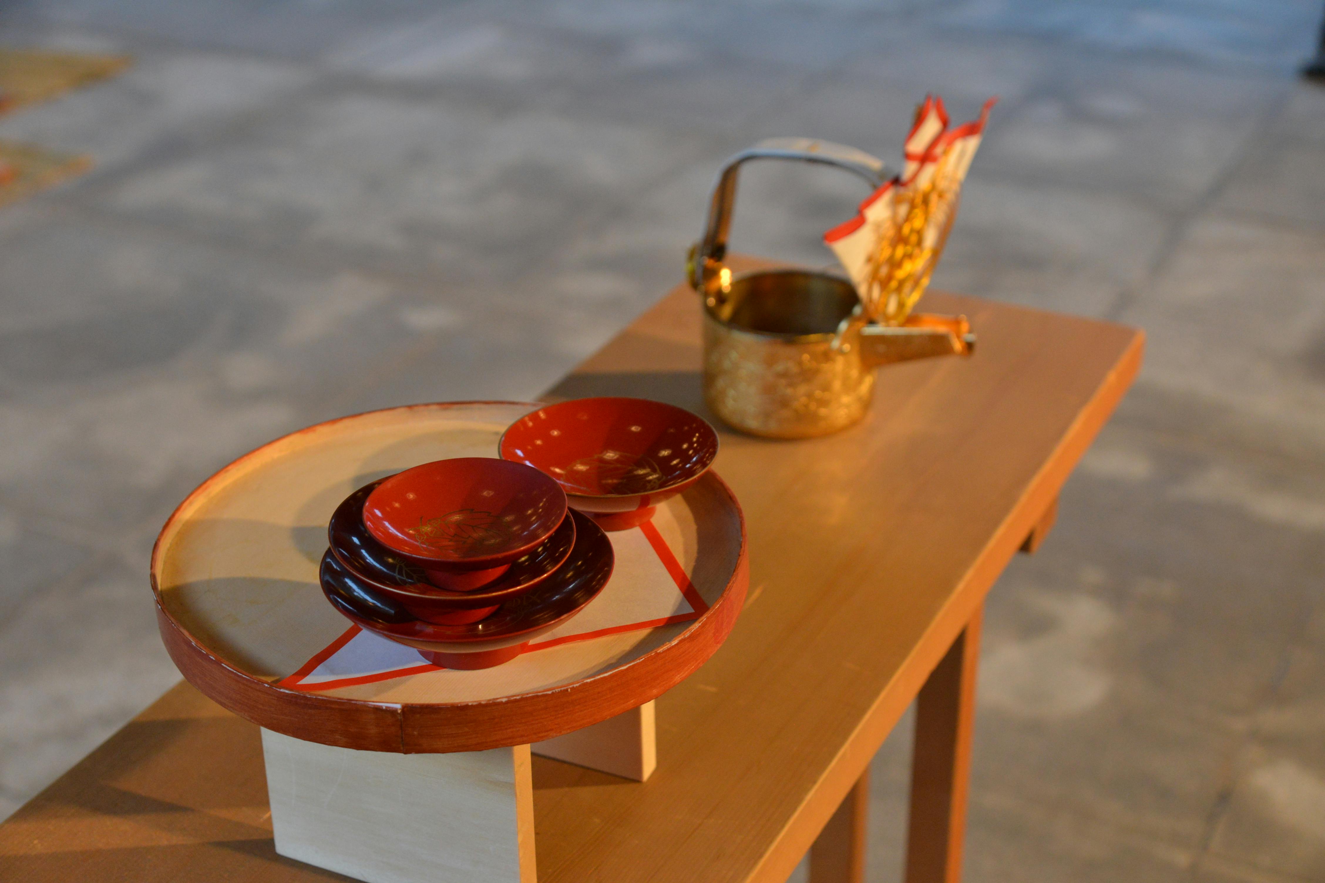 A serene display of traditional Japanese tea ceremony utensils on a wooden table, capturing elegance in simplicity.