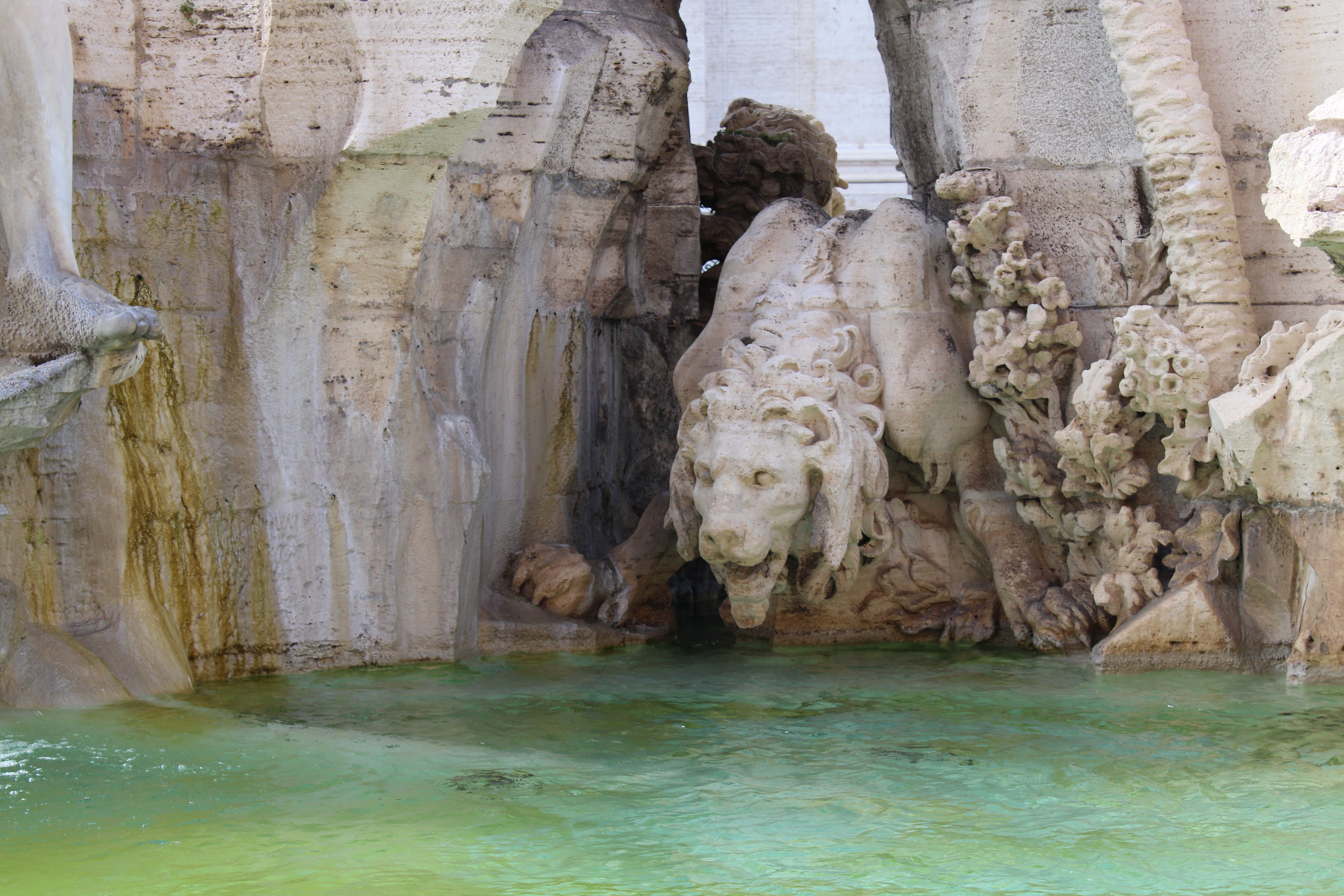 The iconic Trevi Fountain in Rome with its elaborate sculptures and sparkling water, coins visible