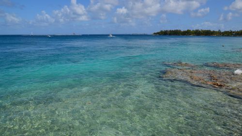 Free Crystal clear water on a tropical seascape with a cloudy sky and distant horizon. Stock Photo