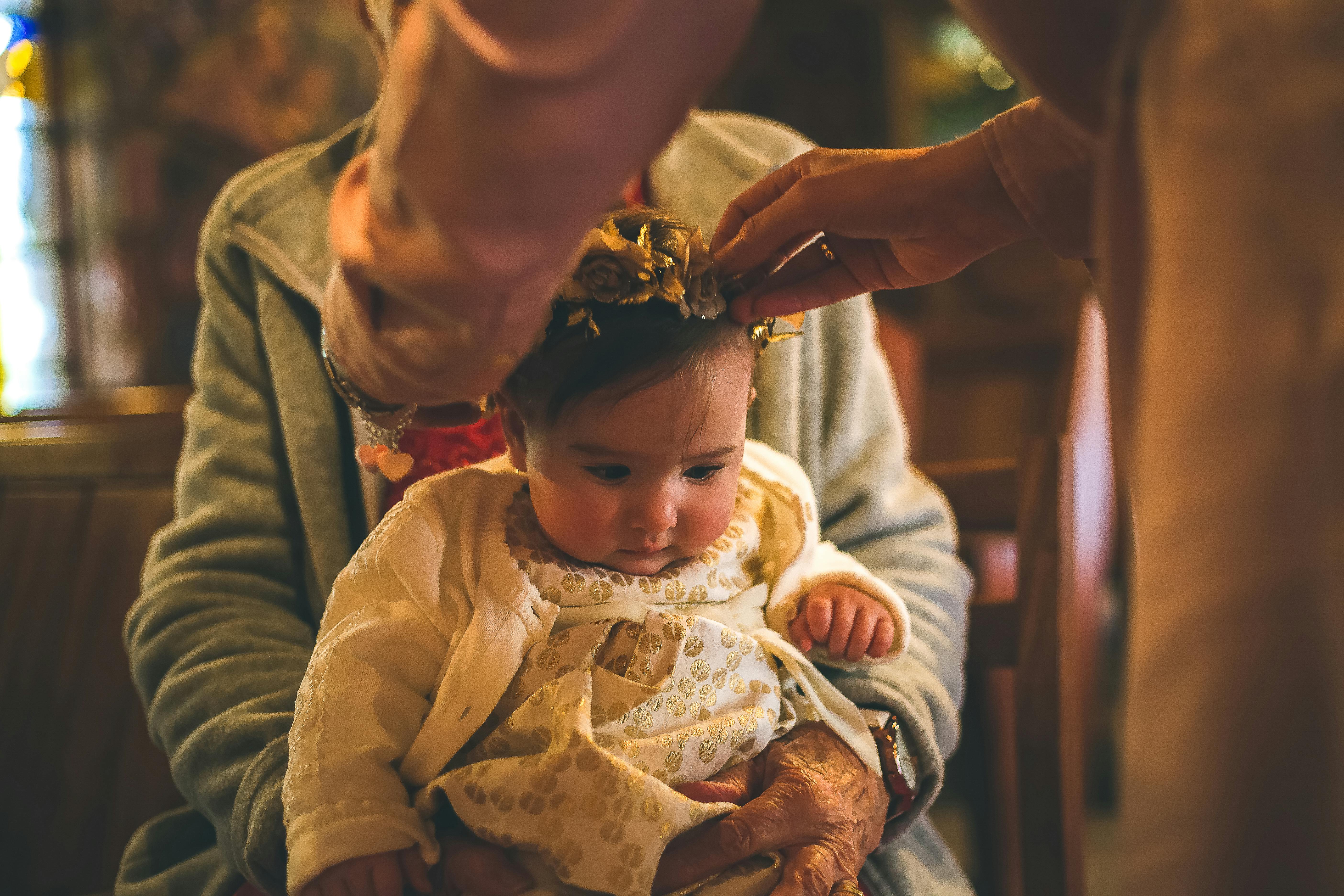 Person Putting Crown On Baby · Free Stock Photo